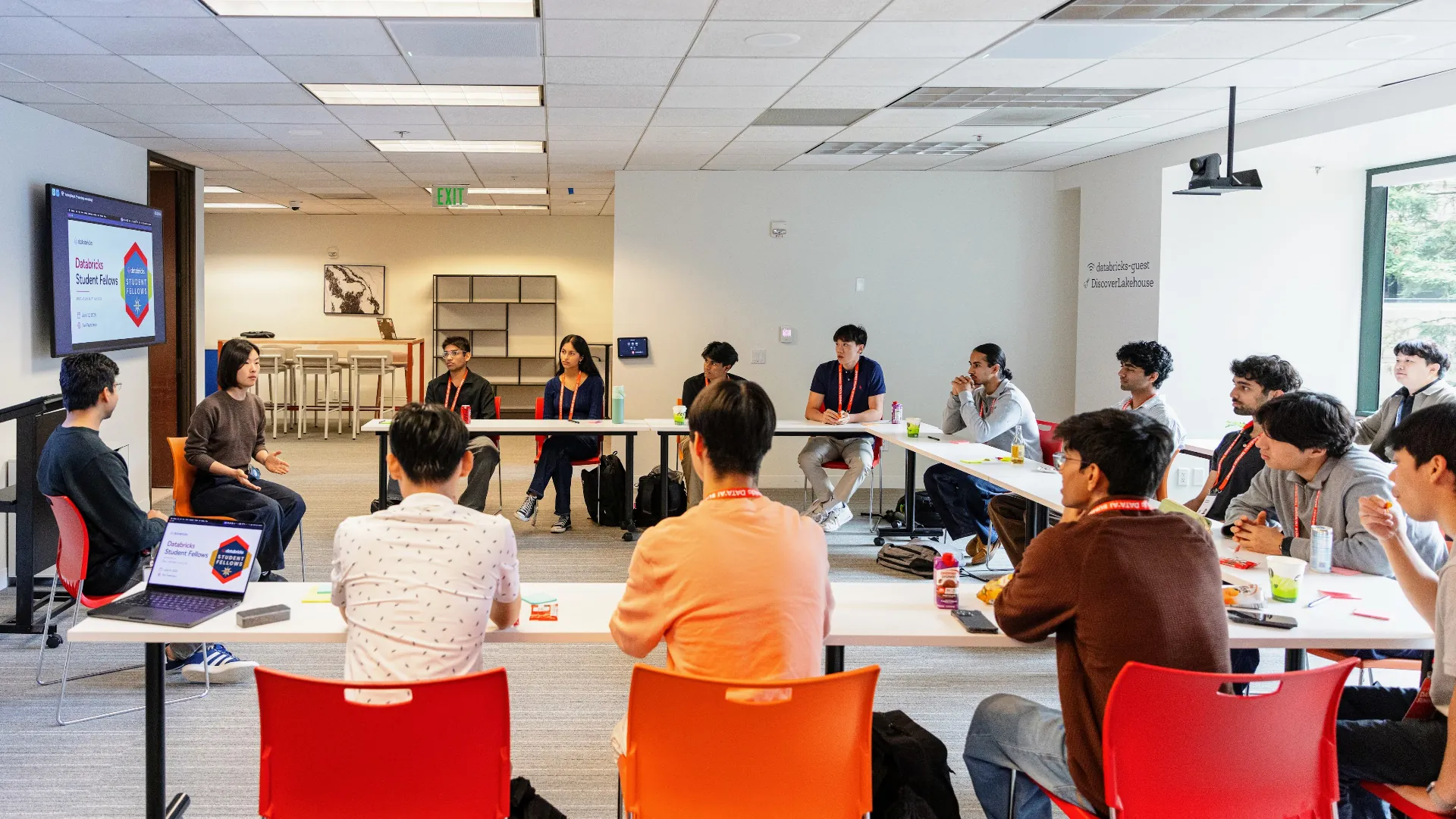 Students seated around tables during a Databricks Student Fellows session